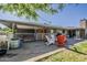 Backyard patio with outdoor seating, a grill, and a large grassy lawn at 125 N Fraser E Dr, Mesa, AZ 85203