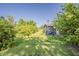 Spacious backyard showcasing a charming outbuilding and lush landscaping at 125 N Fraser E Dr, Mesa, AZ 85203