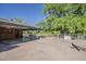 Spacious backyard with a covered patio area, a large tree and plenty of room for activities at 125 N Fraser E Dr, Mesa, AZ 85203
