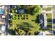 Aerial view of a meticulously maintained backyard with lush greenery, mature trees, and tidy landscaping at 125 N Fraser E Dr, Mesa, AZ 85203