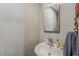 Powder bathroom with a decorative mirror, sink, and convenient fixtures at 125 N Fraser E Dr, Mesa, AZ 85203