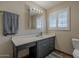 Bathroom featuring vanity, window, and a well-lit mirror at 125 N Fraser E Dr, Mesa, AZ 85203