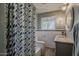 Well-lit bathroom with patterned shower curtain, and modern fixtures at 125 N Fraser E Dr, Mesa, AZ 85203