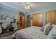 Bedroom with work out equipment, wood floors, ceiling fan, and natural lighting at 125 N Fraser E Dr, Mesa, AZ 85203