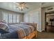 Bedroom with wooden bed frame, closet, and window with blinds at 125 N Fraser E Dr, Mesa, AZ 85203