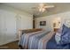 Cozy bedroom with built-in closet space and a view of the ensuite bathroom at 125 N Fraser E Dr, Mesa, AZ 85203