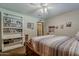 Comfortable bedroom features bookshelf, bedside accessories, and natural light at 125 N Fraser E Dr, Mesa, AZ 85203
