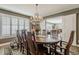 Charming dining area featuring a hardwood table with seating for eight and views into the living room at 125 N Fraser E Dr, Mesa, AZ 85203