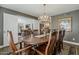 Inviting dining space showcases a table set for eight, with an open doorway view into the adjacent living room at 125 N Fraser E Dr, Mesa, AZ 85203