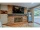 Living room fireplace with brick surround, ideal for cozy evenings at 125 N Fraser E Dr, Mesa, AZ 85203