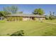 Expansive front lawn with mature landscaping and classic single-story home, complemented by natural light at 125 N Fraser E Dr, Mesa, AZ 85203
