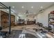 Wide view of gym/workshop featuring a ceiling fan and ample space at 125 N Fraser E Dr, Mesa, AZ 85203