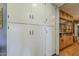 Hallway with floor-to-ceiling cabinets and custom shelving, offering ample storage at 125 N Fraser E Dr, Mesa, AZ 85203