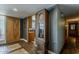 Stylish hallway with dark blue walls and beautiful floors with vintage clock at 125 N Fraser E Dr, Mesa, AZ 85203