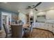 Open kitchen with modern appliances, wood floors, a breakfast table with seating, and ample storage space at 125 N Fraser E Dr, Mesa, AZ 85203