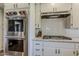 Modern kitchen featuring stainless steel appliances, a cooktop, and granite countertops at 125 N Fraser E Dr, Mesa, AZ 85203