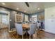Bright eat-in kitchen features a round table with seating, ceiling fan, and views into the dining room at 125 N Fraser E Dr, Mesa, AZ 85203