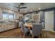 Eat-in kitchen with stainless steel appliances, wood floors, a ceiling fan, and a round table with seating at 125 N Fraser E Dr, Mesa, AZ 85203