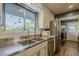 Stainless steel sink, stainless appliances, white backsplash and a large window at 125 N Fraser E Dr, Mesa, AZ 85203