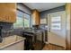 Functional laundry room equipped with a washer, dryer, sink, and storage cabinets at 125 N Fraser E Dr, Mesa, AZ 85203