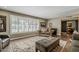 Inviting living room with hardwood floors, large window shutters, and elegant furniture, creating a cozy atmosphere at 125 N Fraser E Dr, Mesa, AZ 85203