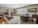 Bright living room with large windows, cozy seating, and stylish decor at 125 N Fraser E Dr, Mesa, AZ 85203