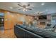 Cozy living room featuring wood paneled walls, a fireplace, and comfortable seating at 125 N Fraser E Dr, Mesa, AZ 85203