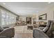 Spacious living room showcasing hardwood floors, natural light from window shutters, and cozy seating arrangements at 125 N Fraser E Dr, Mesa, AZ 85203