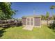 Outbuilding in the backyard, fenced area, with a lush green lawn at 125 N Fraser E Dr, Mesa, AZ 85203