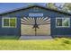 Barn-style outbuilding featuring unique custom doors and ample lighting at 125 N Fraser E Dr, Mesa, AZ 85203