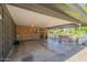Covered patio with brick detail, plenty of storage, and view of the backyard at 125 N Fraser E Dr, Mesa, AZ 85203