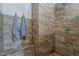 Shower featuring two shower heads, a bench and wood-style tile at 125 N Fraser E Dr, Mesa, AZ 85203