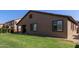 Large backyard featuring a well-maintained lawn and a covered patio area, perfect for outdoor gatherings and relaxation at 14556 W Shaw Butte Dr, Surprise, AZ 85379