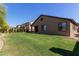 Spacious backyard with green grass and manicured landscaping, creating a serene and inviting outdoor space at 14556 W Shaw Butte Dr, Surprise, AZ 85379