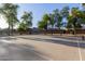 Community basketball court with lighting and trees, perfect for outdoor recreation at 14556 W Shaw Butte Dr, Surprise, AZ 85379