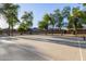 Outdoor basketball court with mature trees and lighting for evening play at 14556 W Shaw Butte Dr, Surprise, AZ 85379