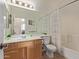 Well-lit bathroom with a large mirror, single sink vanity, and a shower/tub combination at 14556 W Shaw Butte Dr, Surprise, AZ 85379