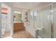Well-lit bathroom with a separate shower and tub, wooden cabinets, and decorative wall art at 14556 W Shaw Butte Dr, Surprise, AZ 85379