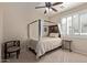Comfortable bedroom featuring a stylish canopy bed and a window with elegant shutters at 14556 W Shaw Butte Dr, Surprise, AZ 85379
