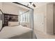 Serene bedroom showcasing a canopy bed, complemented by a window with plantation shutters at 14556 W Shaw Butte Dr, Surprise, AZ 85379