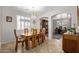 Open dining area featuring a chandelier, a wooden table with six chairs, and tiled flooring at 14556 W Shaw Butte Dr, Surprise, AZ 85379