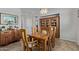 Dining room with wood table, six chairs, a china cabinet, and tiled flooring at 14556 W Shaw Butte Dr, Surprise, AZ 85379