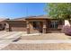 Charming single-story home featuring a well-maintained yard and a two-car garage at 14556 W Shaw Butte Dr, Surprise, AZ 85379