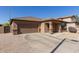 Well-maintained single-story home with a two-car garage and rock landscaping at 14556 W Shaw Butte Dr, Surprise, AZ 85379