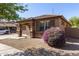 Side view of a well-maintained single-story home with manicured landscaping at 14556 W Shaw Butte Dr, Surprise, AZ 85379