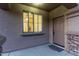 Inviting front porch with stone accents, a welcome mat, and a view into the home at 14556 W Shaw Butte Dr, Surprise, AZ 85379