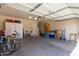 Spacious garage with ample storage, bicycles, and access to additional house features at 14556 W Shaw Butte Dr, Surprise, AZ 85379