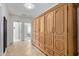 Hallway with a large wooden storage cabinet and access to other rooms at 14556 W Shaw Butte Dr, Surprise, AZ 85379