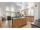 Open kitchen with a large island, wooden cabinets, and stainless steel appliances at 14556 W Shaw Butte Dr, Surprise, AZ 85379