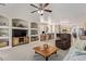 Spacious living room featuring custom built-ins, an inviting seating area and open access to kitchen at 14556 W Shaw Butte Dr, Surprise, AZ 85379